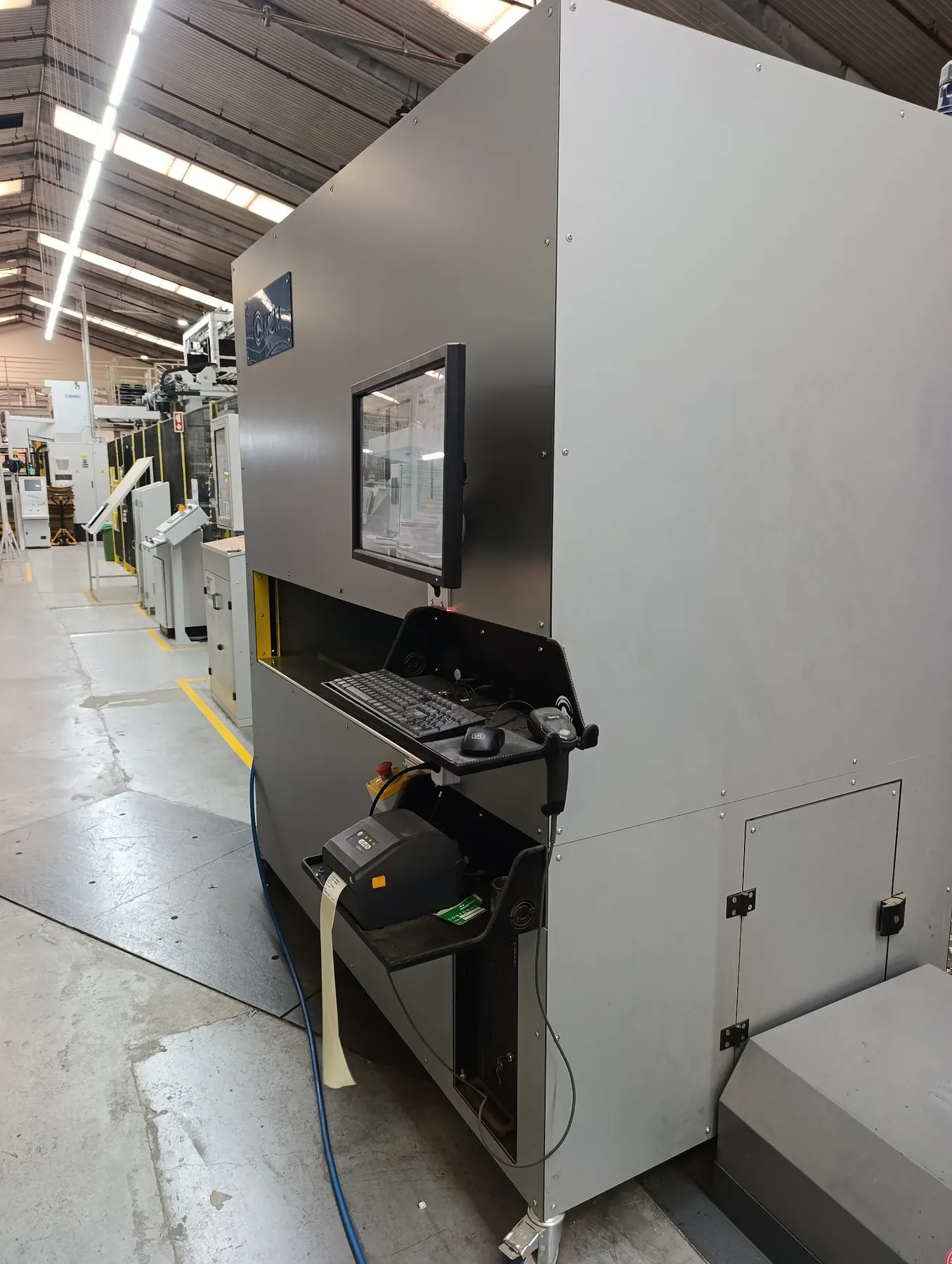 Side view of an MCM Industrial Scanner used for packaging inspection in a factory